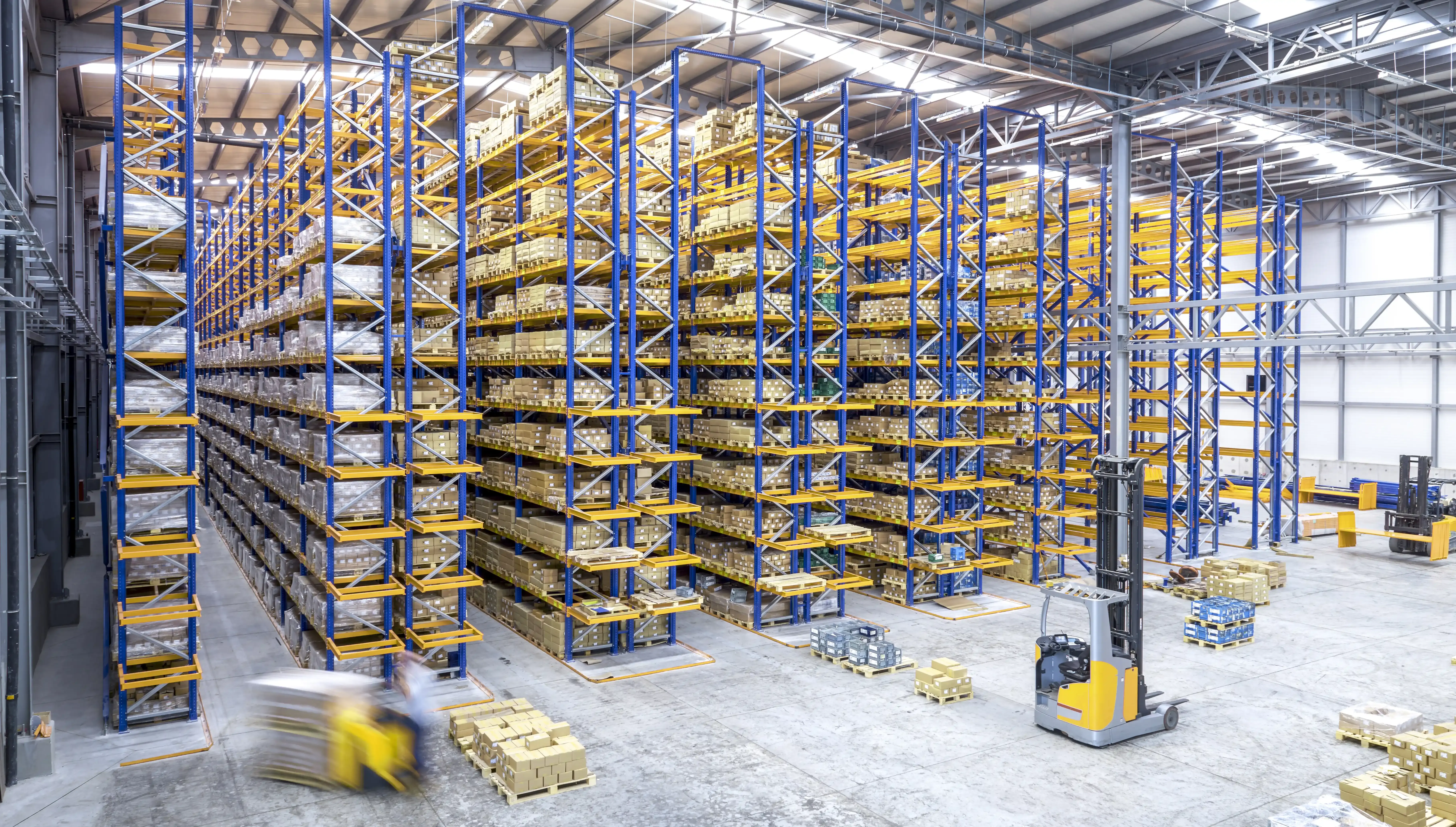 blue and yellow high shelves in a warehouse